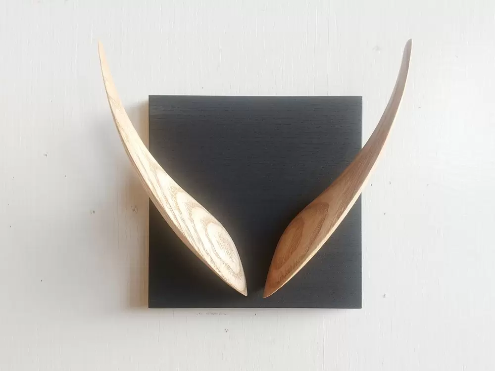 “V” wall hanging object that “looks like an alphabet if you look closely” 