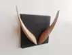 “V” wall hanging object that “looks like an alphabet if you look closely” 